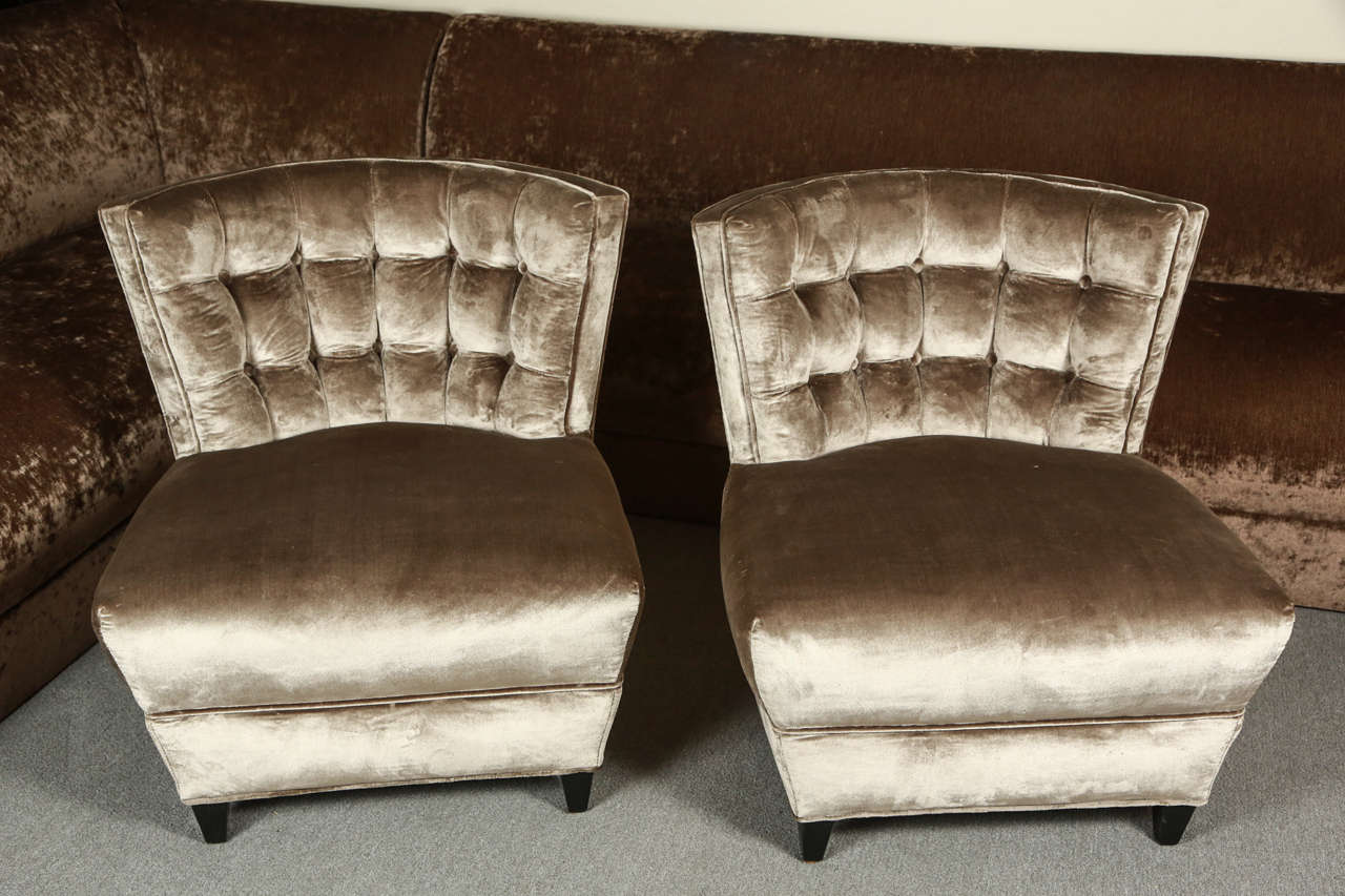 Pair of exquisite slipper chairs by James Mont.
The backs are tufted and they are newly reupholstered in a beautiful silvery  silk velvet.