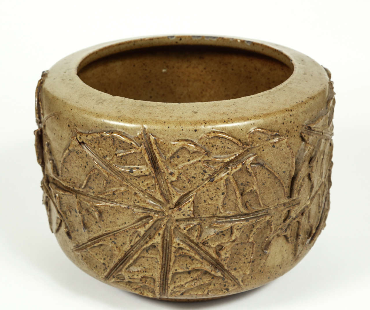 Hand thrown 4074 tire pot in solar pattern with olive glaze for Architectural Pottery.