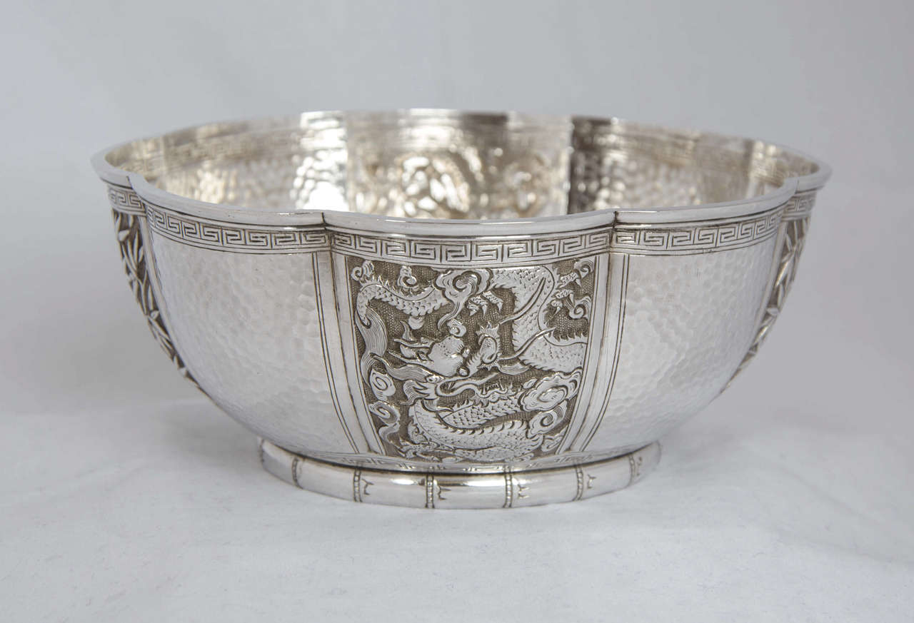 A pair of Chinese silver bowls of hexagonal form with panels of dragons and bamboo as shown.
They have the mark for Tu Mao Xing of JiuJaing, circa 1895.
The 2 bowls together weigh 391gms.
 