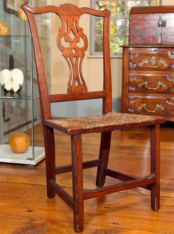 A New England country Chippendale period chair in old surface with owls eye backsplat, well formed ears, woven rush seat and square beaded legs. See Historic Deerfield Collection for Identical Example.