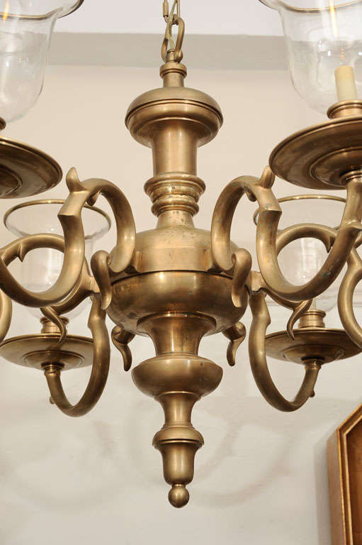 Important Federal Style six-light Brass Chandelier created in the 1930s has brass-rimmed hand-blown hurricane shades mounted above substantial spun-brass bobeshes.

Reduced From: $7800