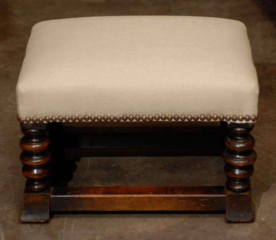 English upholstered foot stool with stretcher.