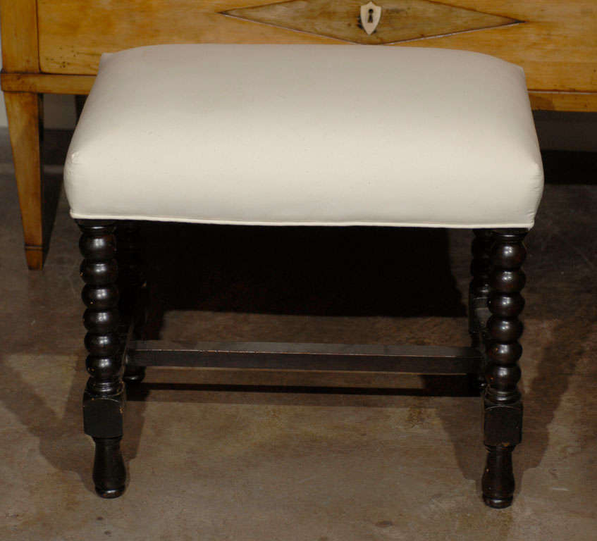 Pair of French bobbin leg stools with new muslin upholstery.