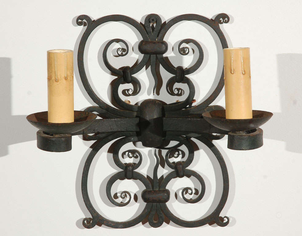 Pair of French iron double sconces.