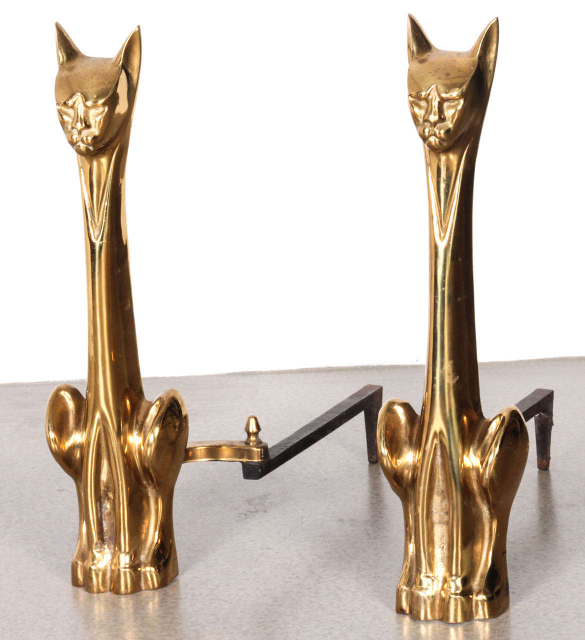 Pair of polished brass, cat figure andirons with cast iron supports.