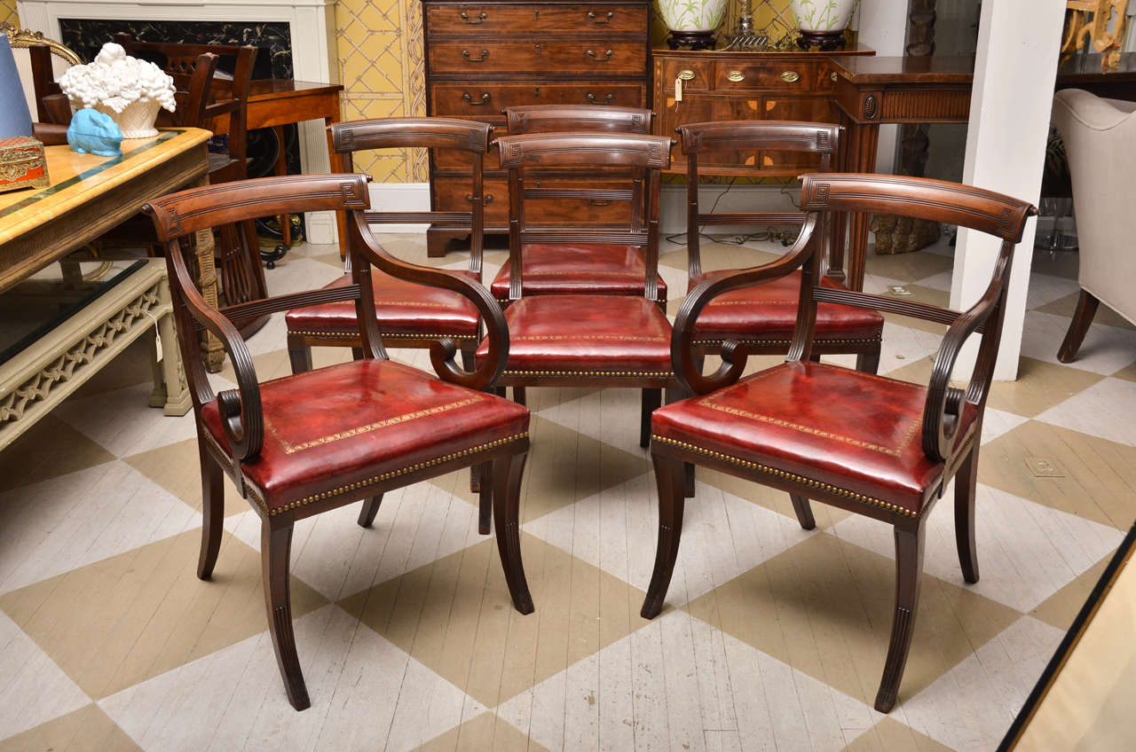 Circa 1900, Set of Six English Regency Style Mahogany Dining Chairs Having Two Armchairs and Six Side Chairs.  Each having
Red Leather Seats with Gold Tooling