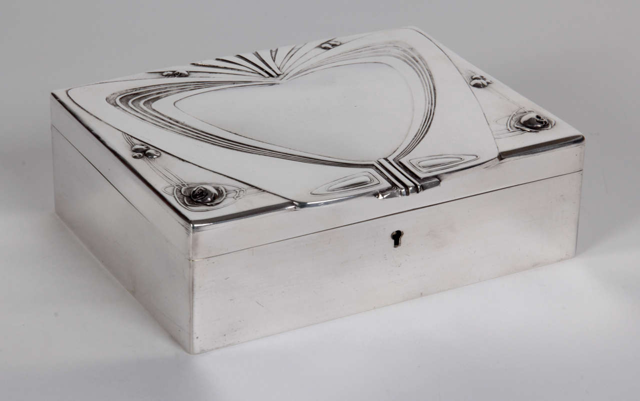 SCHOOL OF MACKINTOSH (1868-1928) UK

Box with hinged cover  c. 1900

Silver plate with a large abstract heart design and stylized Glasgow rose motifs in bas-relief.

Illustrated: Modern Silver throughout the world, 1880-1967, Graham Hughes