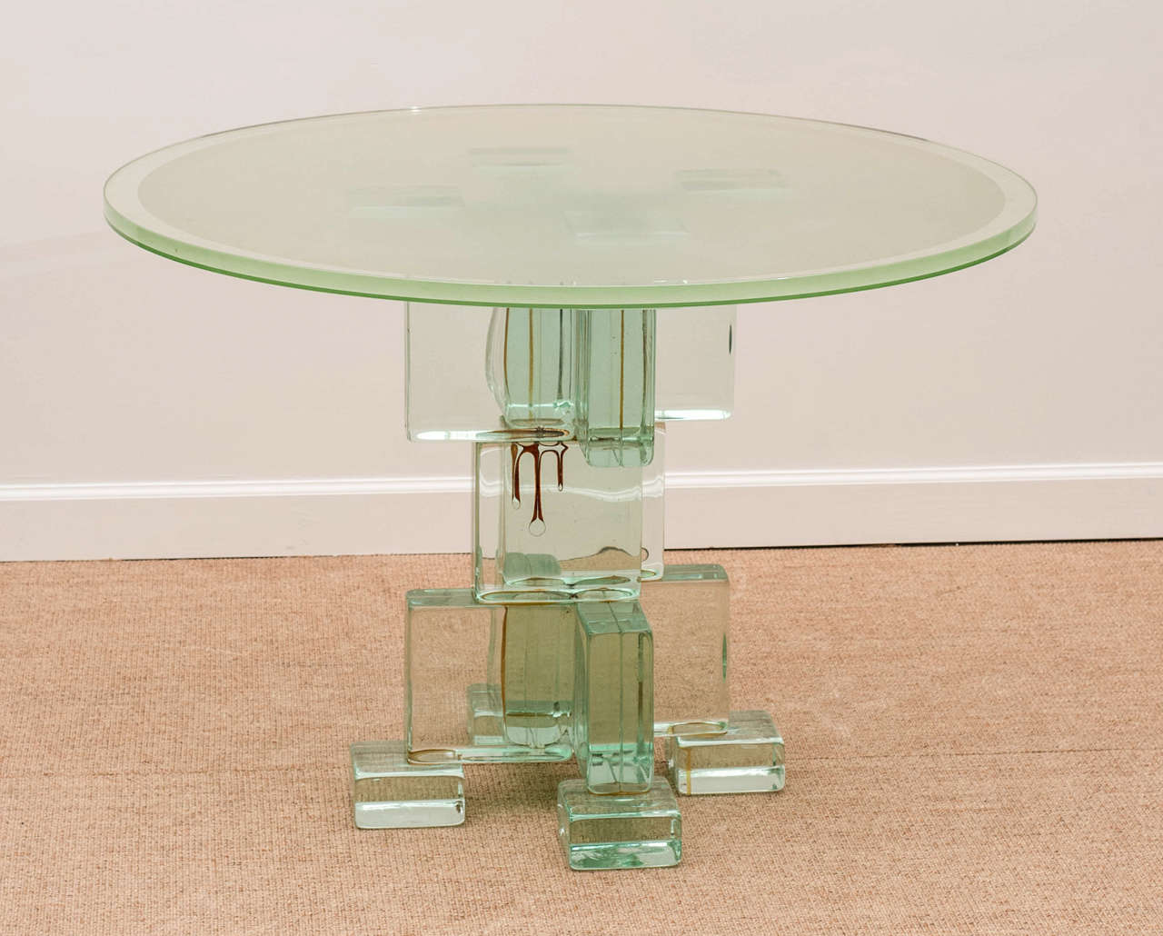 A unusual vintage glass center table with a block work base.

View our complete collection @ www.hollisandknight.com.