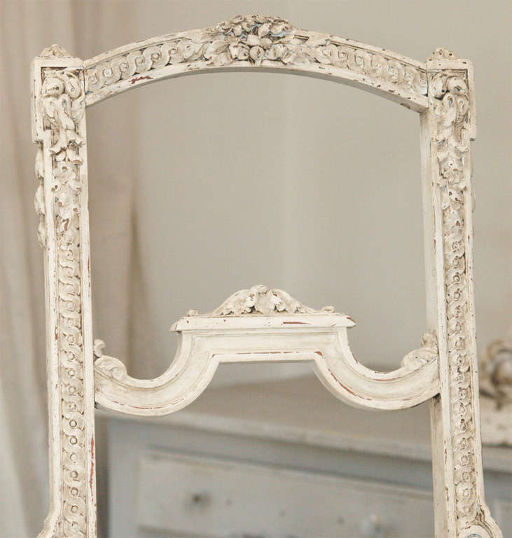 Charming Louis XV french parlor chair, painted in a belgian white with beautiful aged patina and exquisite rose and ribbon carvings.  Newly upholstered in an organic muslin with tufted seat.  Cabriole legs.