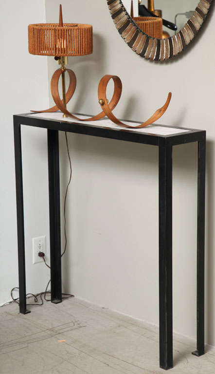 Unique black iron console table with an inset marble top, surmounted by a curl of black walnut pierced by a brass lamp standard. Retaining original hemp-wrapped shade and walnut finial.