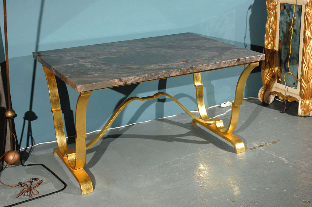 Wrought iron with 22-karat gold leaf finish entry centre console table with marble top by Raymond Subes
biography:

(French, 1893-1970)

Subes is one of the most renowned French metalworker of the Art Deco period.

He became director of the