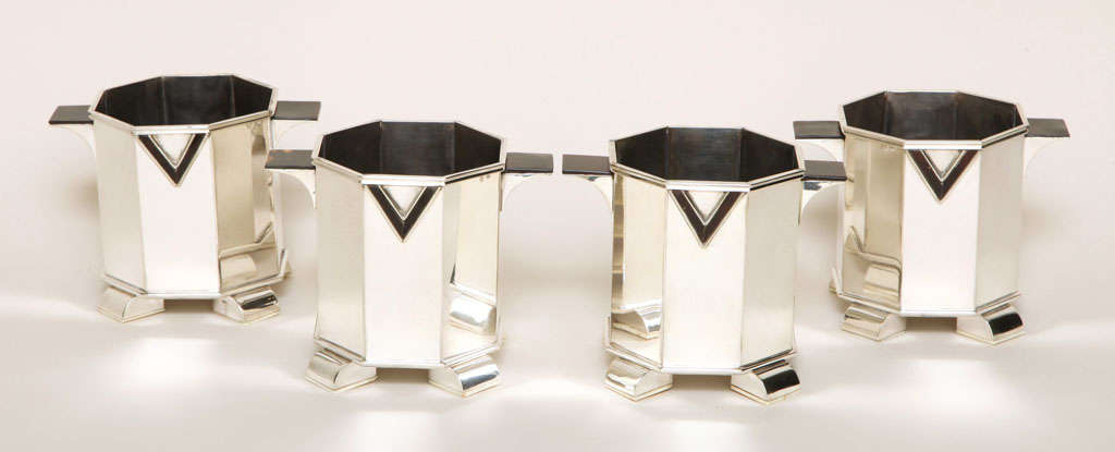 Exquisite set of four small sterling silver wine caddies with faux tortoiseshell details on lateral handles & V-pattern on front and back and resting on bone feet bases by Maison Cardeilhac, Paris.

Hallmarks: 950 silver/ Cardeilhac