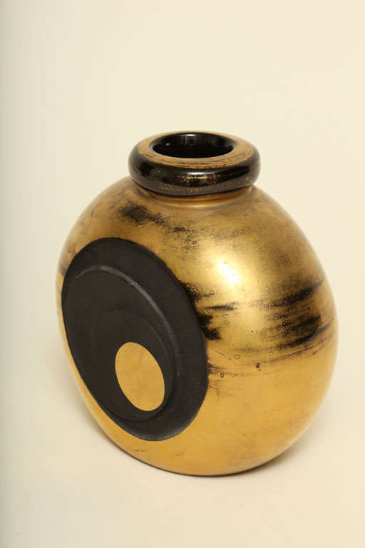 Black glass vase has acid etched circles with gilding over the non-etched body and decoration repeated on the reverse side by Jean Luce (1895-1964), Paris.
Signed: artist's monogram

Jean Luce worked as a designer in a cubist-inspired style,