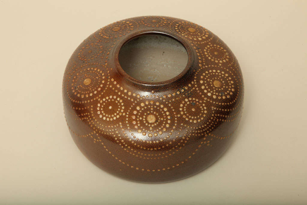 Salt-glazed stoneware vase is decorated with thick white glaze dots (some with gold) in a pattern of concentric circles on brown glaze background by Henri Simmen (1880-1963).
Signed: 