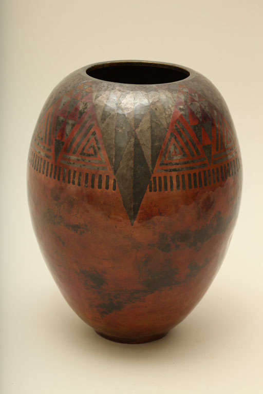 This ovoid copper vase has silver triangles and a geometric pattern and lines on a red copper ground by Claudius Linossier (1893-1953).
Incised: CL-LINOSSIER 1927

Variety of other Linossier vases available.