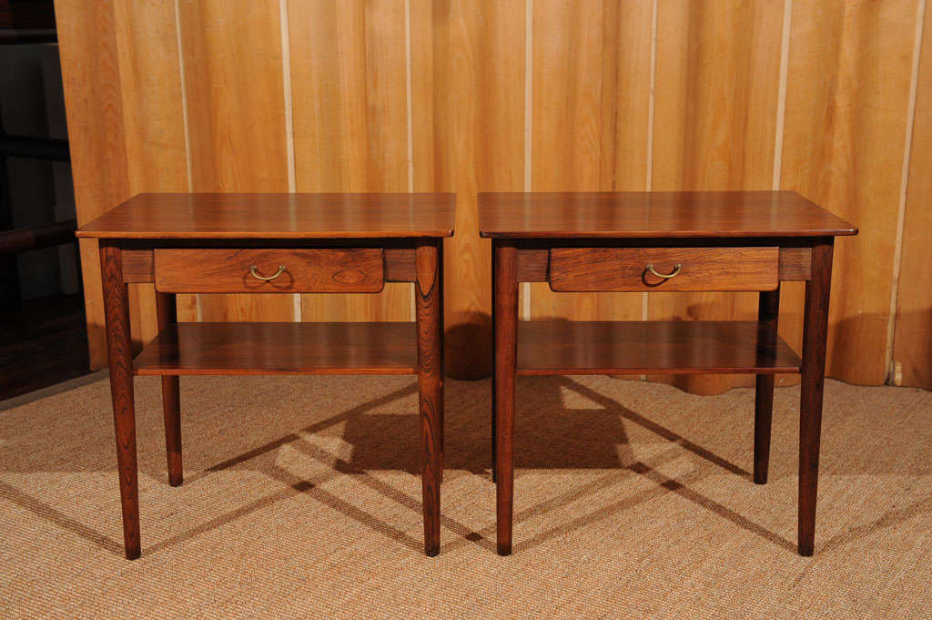 Wonderful pair of high quality Danish rosewood side tables. Fully extending small drawer and shelf. Brass pulls.
