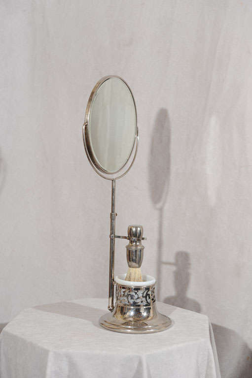 This very lovely shaving mirror and stand would make a great accent piece to a dresser or in a bathroom.  It is hard to find one with the nice original nickle plated brush and original glass insert.  The height of the mirror can be adjusted from 15