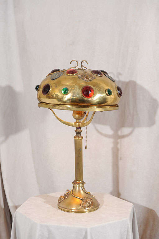 This colorful and exotic lamp is very decorative and collectible. The colorful jewels and applied flowers make this a very special lamp. We've seen this style before with these flowers and jewels and they are occasionally signed by the Bradley and