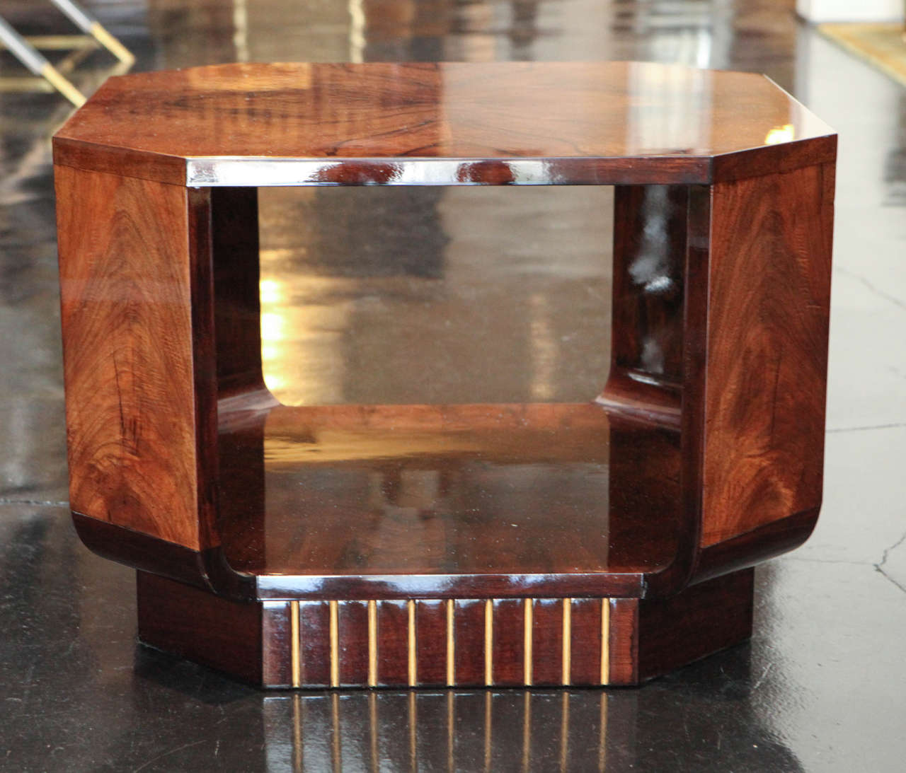 Side table in mirrored walnut burl on top and lower tier. Octagonal in shape with engraved linear detailing in gold leaf on base.