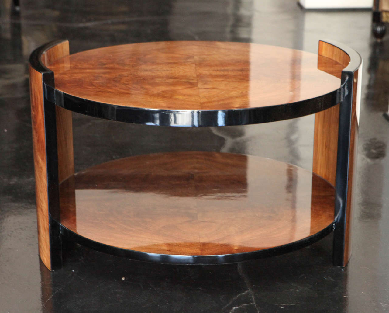 Oval, two-tiered side table with book-matched walnut crotch veneer. Black lacquer detailing around sides. Wonderful as smaller coffee table as well.