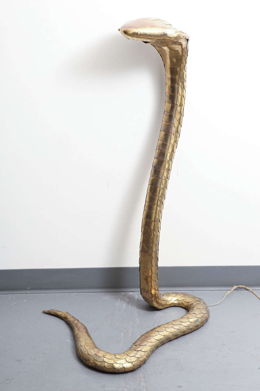 Fabulous large-scale cobra finely articulated with scales and rich patinated surface. A small light bulb is located in the mouth and is illuminated with a floor foot switch. Signed 
