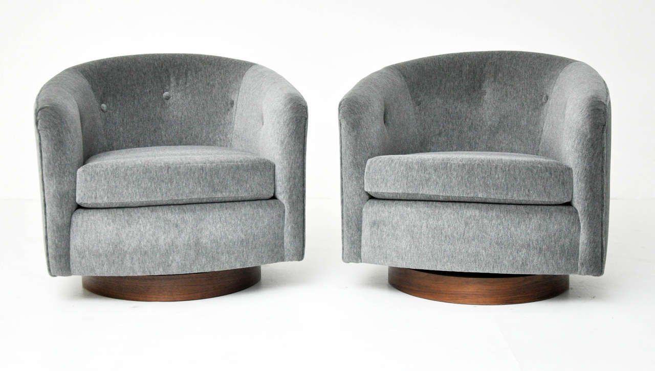 Pair of swivel chairs designed by Milo Baughman. Chairs rock and swivel. Fully restored and reupholstered. Walnut bases.