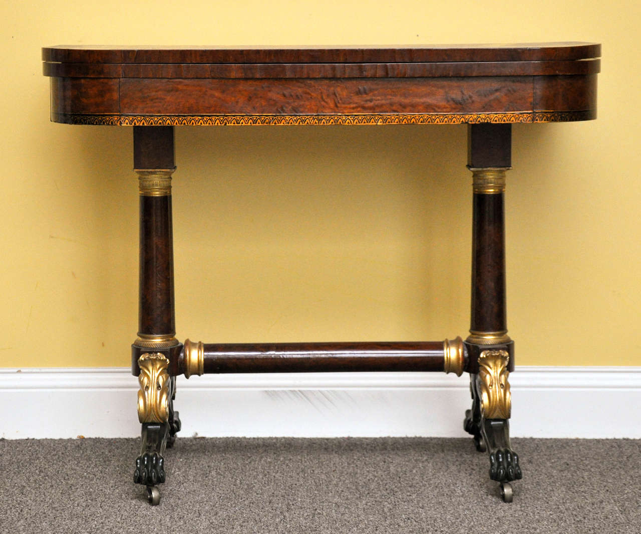 Rare light-wood burl ash card table with cheval supports, ormolu mounts, gilt stencil work and gilt verd-antique feet. The feet are especially fine in form, possibly by Lannuier's shop.
New York City, circa 1820.
Primary woods, burl or swirl ash
