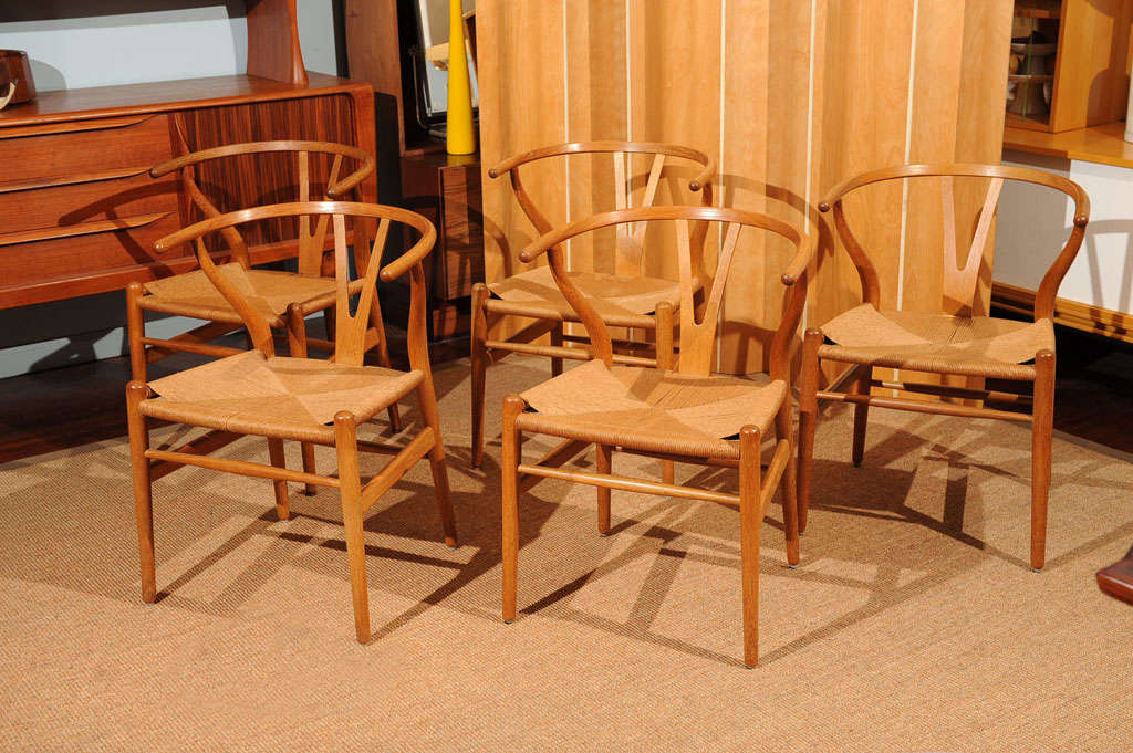 Original set of ten Hans Wegner wishbone chairs in excellent original condition. Purchased from Illums Bolinghus, Denmark.