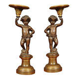 Pair of Patinated Bronze and Parcel Gilt Putti-form Candlesticks