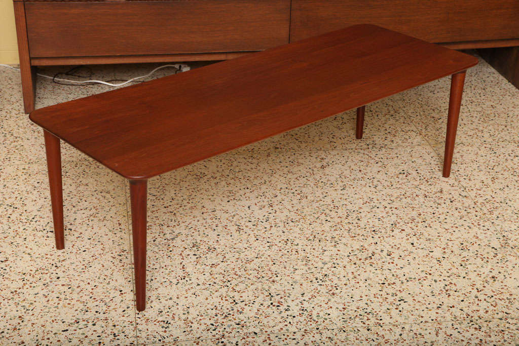 REDUCED FROM $1800...Exceptional long size and attention to detail in design features and construction sets this Danish teak table apart. First, the solid one inch thick staved teak top in a longboard length with its warm patina and beautifully