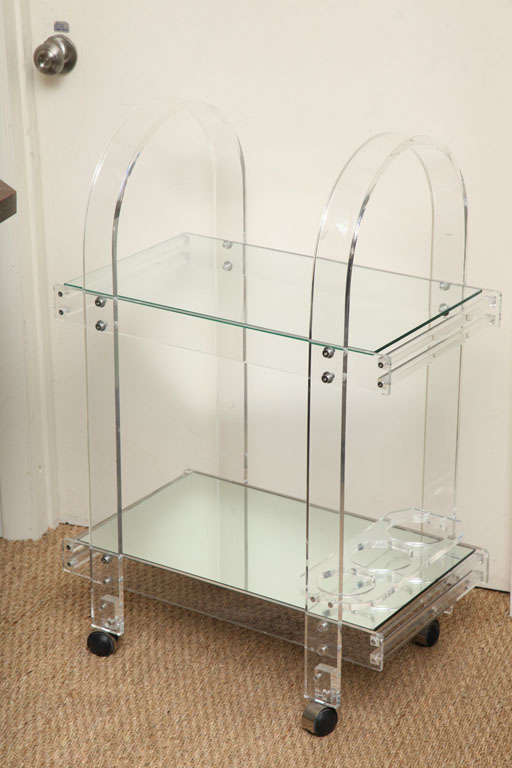 A TWO TIER BAR CART IN CLEAR LUCITE
