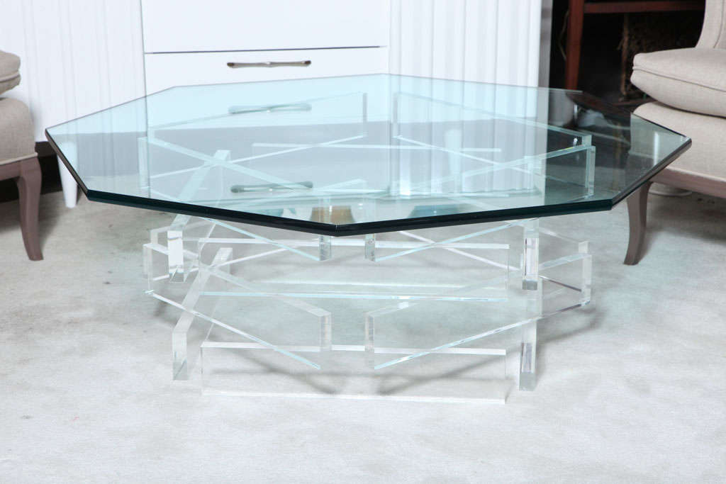 The glass top seats in a beautifully Pentagonal Lucite base, the combination of materials and shape of the base create a sort of tridimensional effect. The Base is in excellent condition for the age, the Lucite is totally clear. The glass is 45