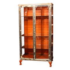 Used orange, white and steel medical cabinet