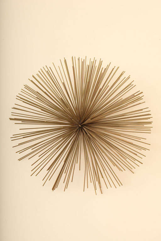 This miniature pom pom  metal sculpture  by Curtis Jere will bring dimension to any wall.