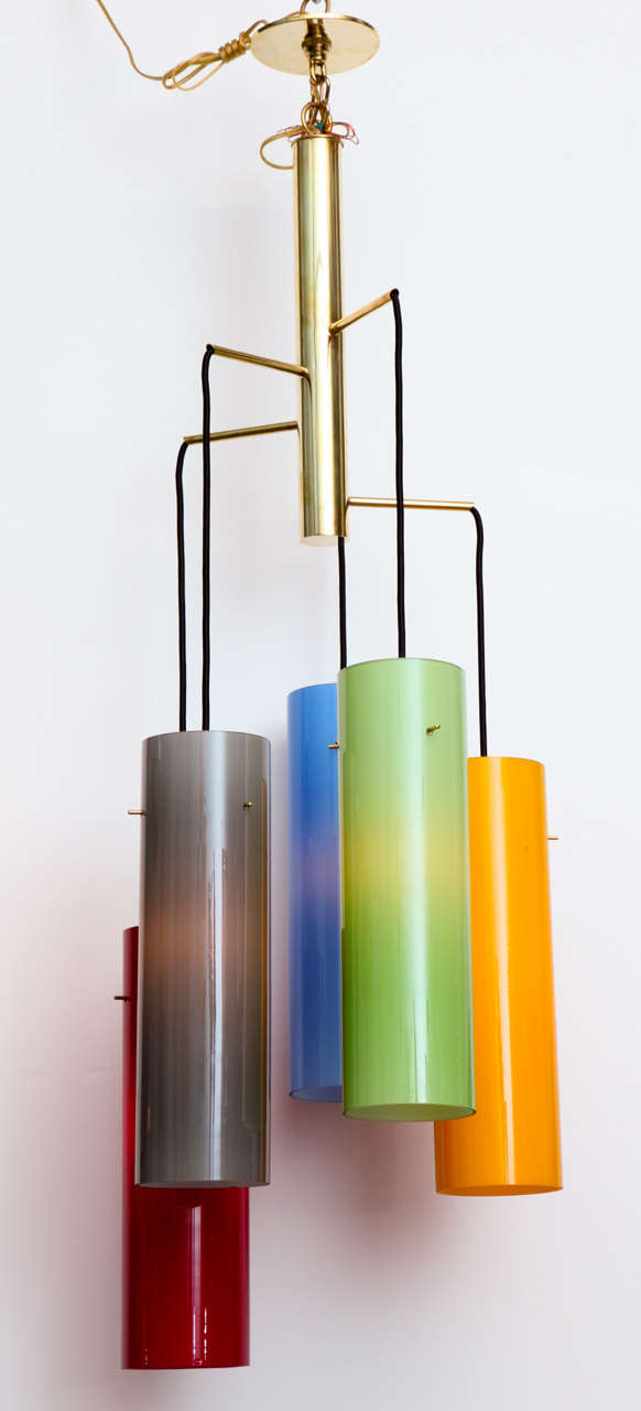 Unusual fixture with five brightly colored, cased glass shades. Polished brass center piece with arms extending at different heights. A great example of 1960s Italian Modernism.