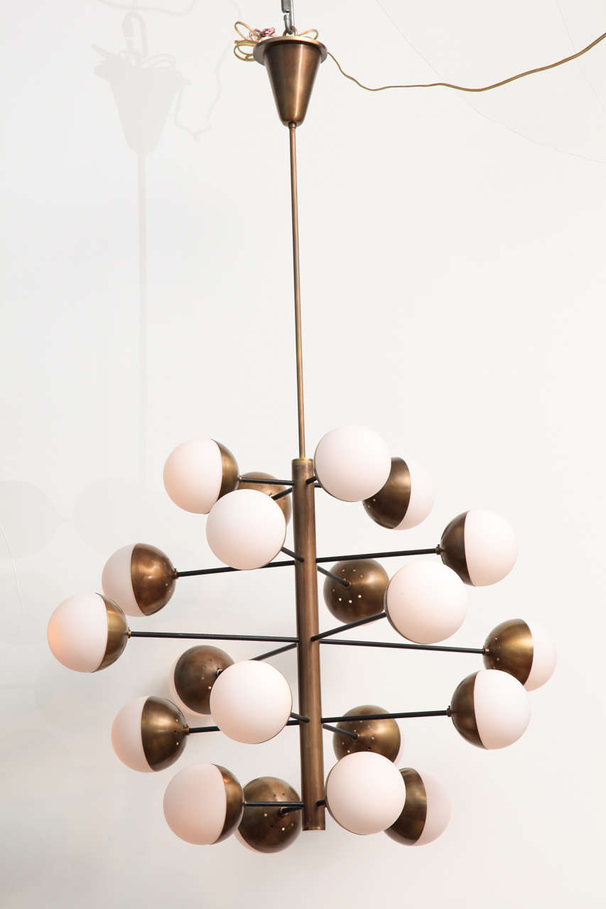 Extraordinary, large scale fixture with 20 lights.  Black painted metal, brass, and frosted glass ball shades.  This model is very rare and has a strong presence.