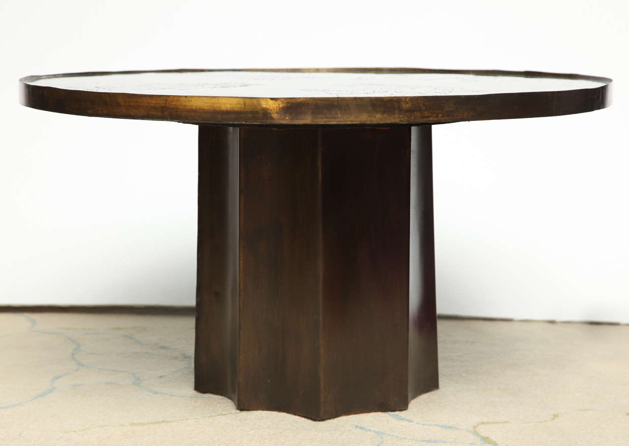 Single commission, studio-made table with a circular bronze top, torched finish and etched figures of goddesses and muses. The diameter of the top and the presence of a fluted column base make this form completely one-of-a-kind. The etchings on this
