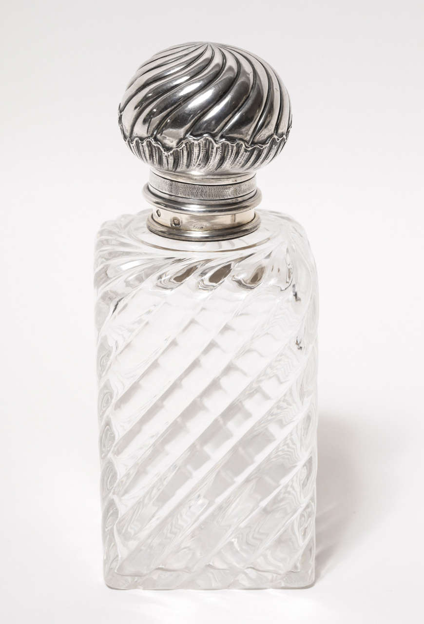 With spiral cut crystal body, glass stopper and intricately chased silver top.
Hallmarks:  950 silver/ ES lion's head/ stamped inside of top MERITE/ E.SANNER S/ 3 RUE DU 4 SEPT/ BRE/ PARIS