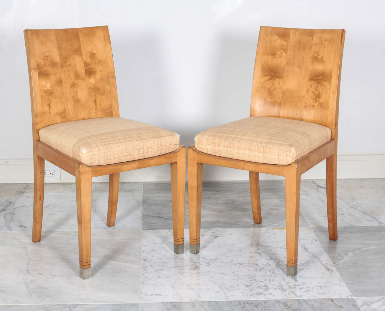 Pair of Jean-Michel Frank sycamore chairs with raffia upholstered seats. Authenticated by the Jean-Michel Frank Committee. Provenance: Hemisphere Gallery, London.