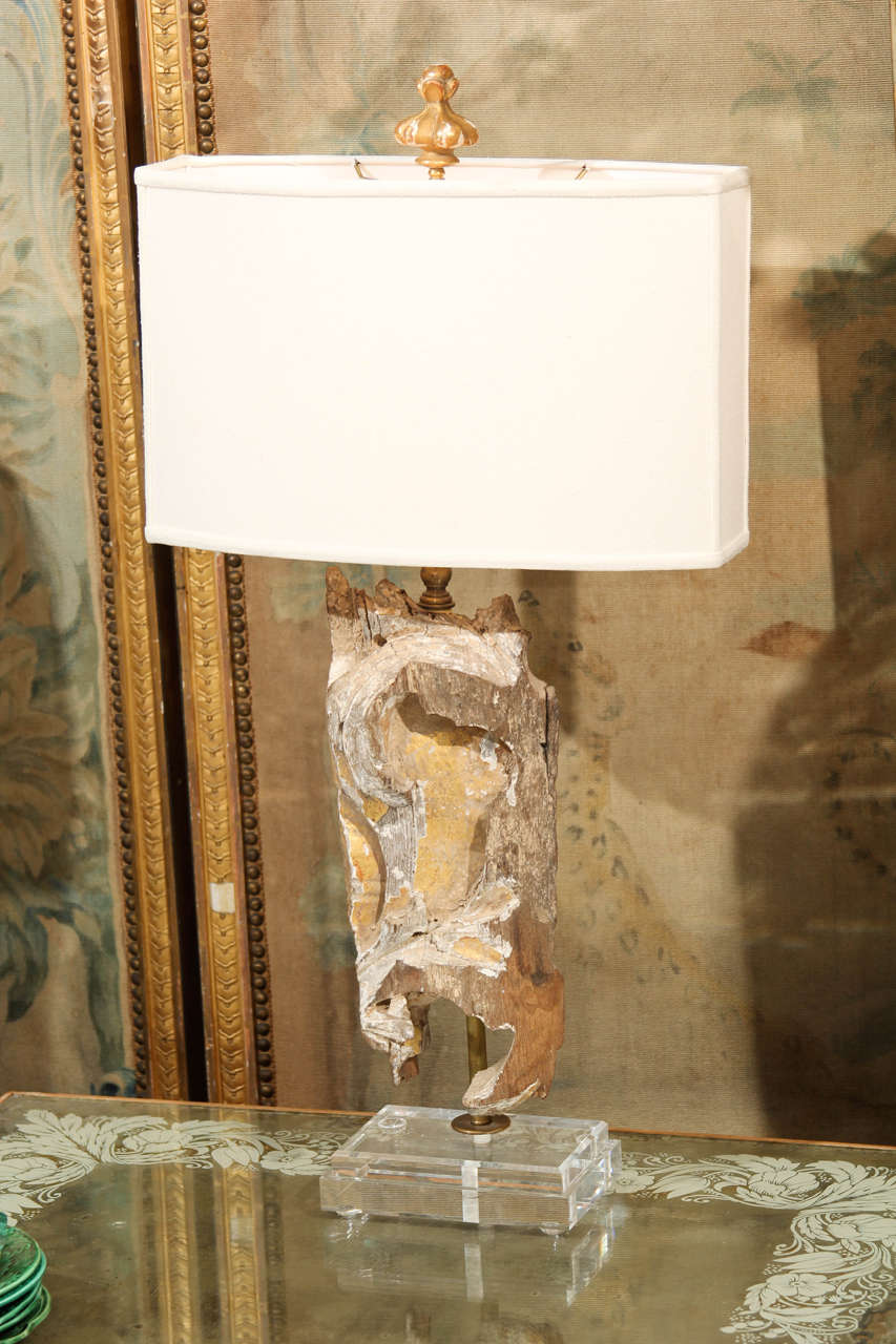 Custom lamp of gilded French fragment on plexiglass base. Linen shade with fragment finial.
