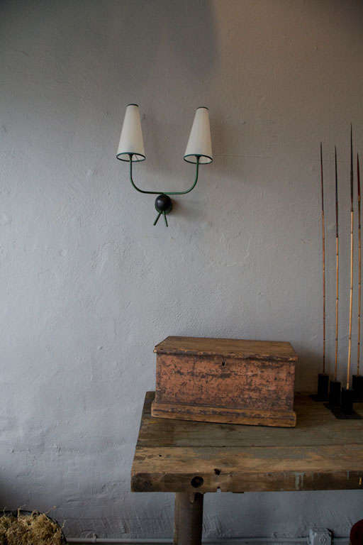 an original pair of sconces by french designer . jean royere.