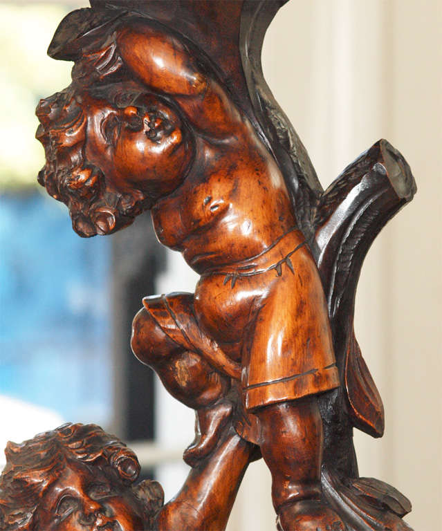19th Century Italian Carved Walnut Stand With Three Putti For Sale