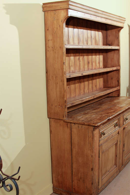 Irish Pine Dresser

This is an original pine dresser from the 19th century.  

It is made in two pieces (for easy moving). The plate rack sits on the pine dresser.  The top features three plate racks and an old pine back.

The bottom has a