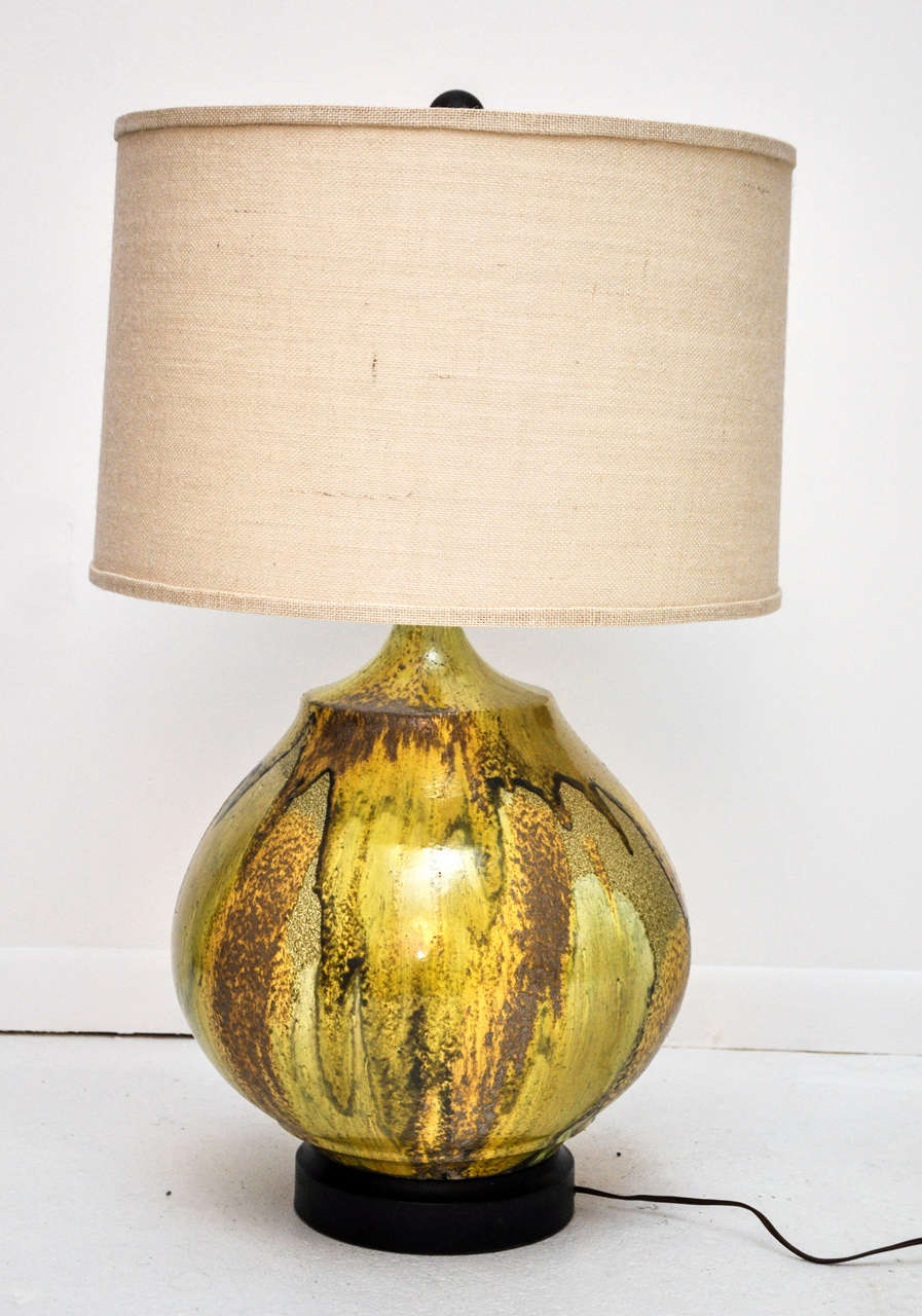 Stunning fully functional table lamp. Base is a unique piece of artisan studio pottery, wired and converted into a lamp. Beige lamp shade is included.