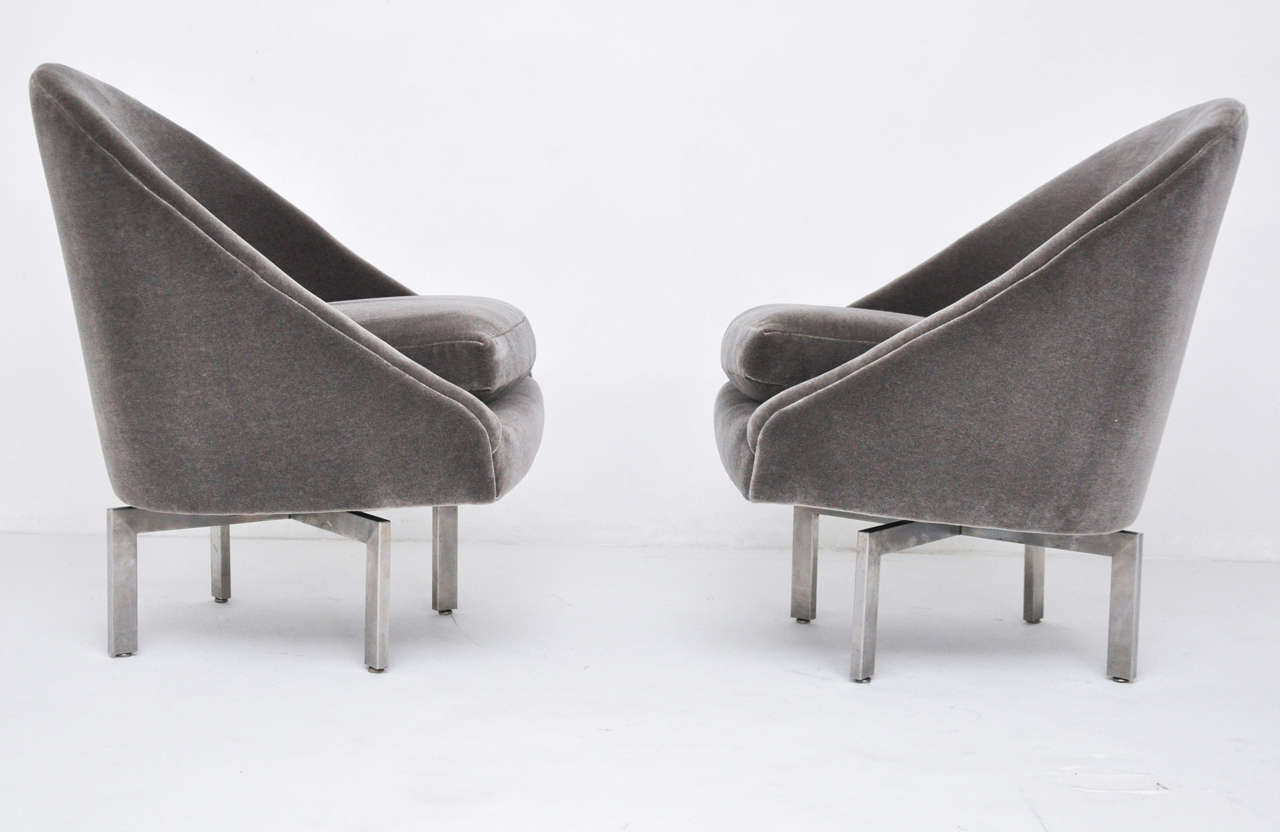 Pair of mid-century swivel chairs on brushed stainless steel bases.  Newly upholstered in grey mohair.