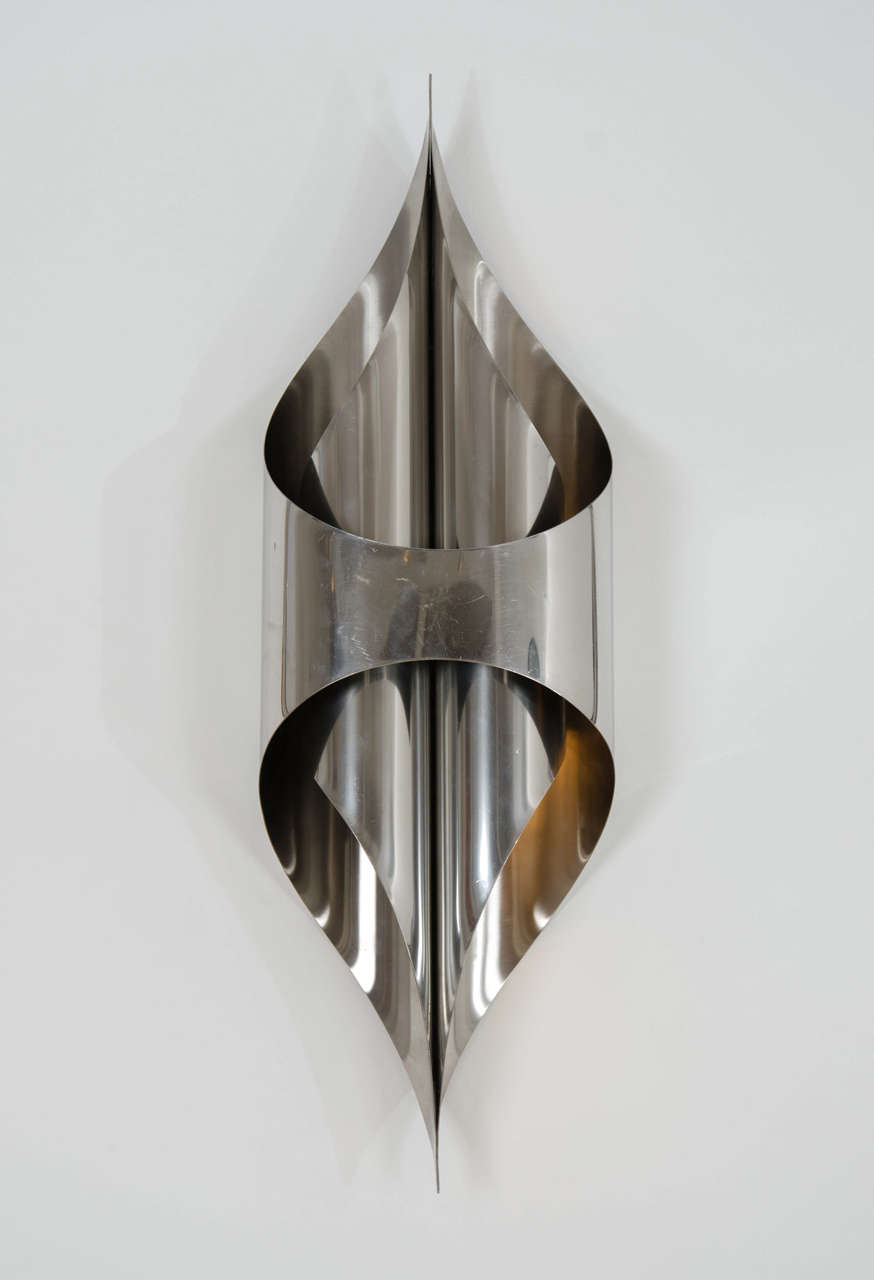 Pair of 1970s 'Fusee' wall lights by Maison Charles, French, 
polished stainless steel
Each: H 80 cm / W 28 cm / D 15 cm.