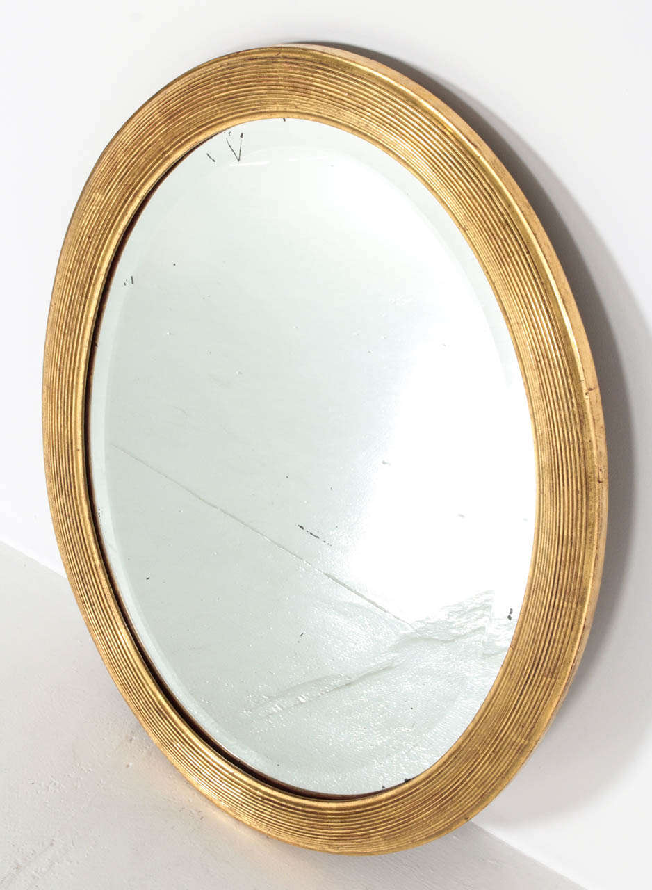 Elegant late 19th-early 20th century mirror with original mirror and recently restored gold leaf frame.
