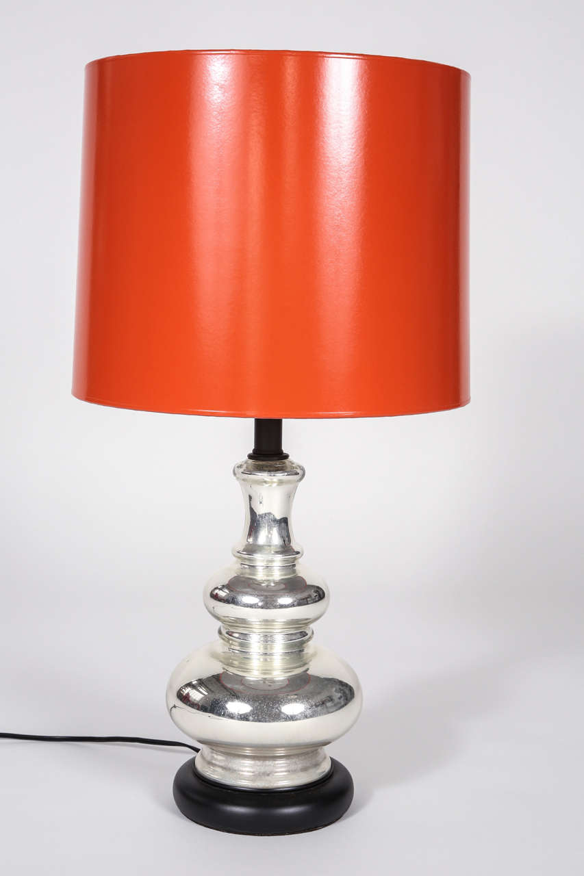 A stunning Mercury tiered mercury glass lamp with an orange Hermes shade that is silvered in the interior. Height to the top of the finial is 28 1/2