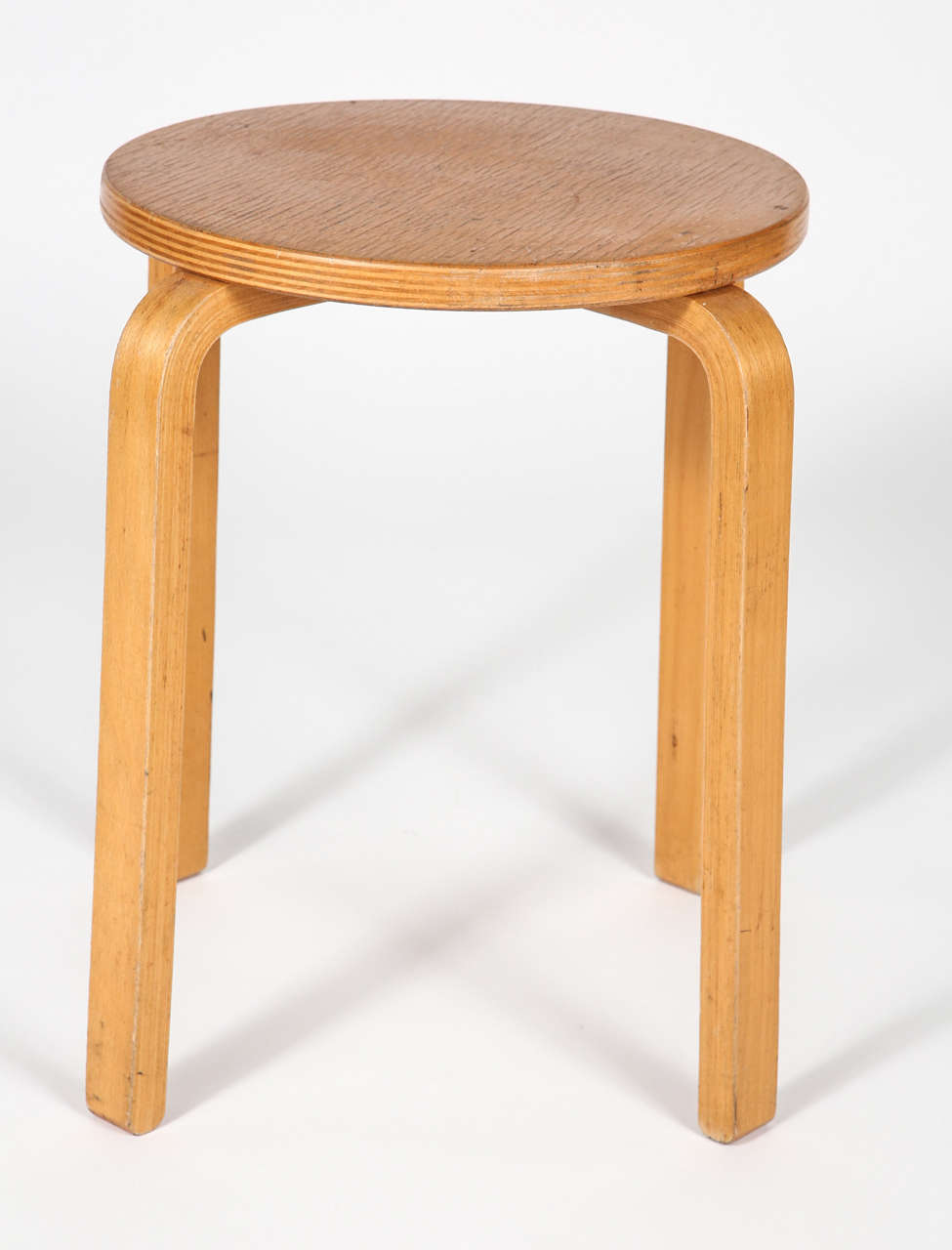 A vintage Alvar Aalto stool in maple.