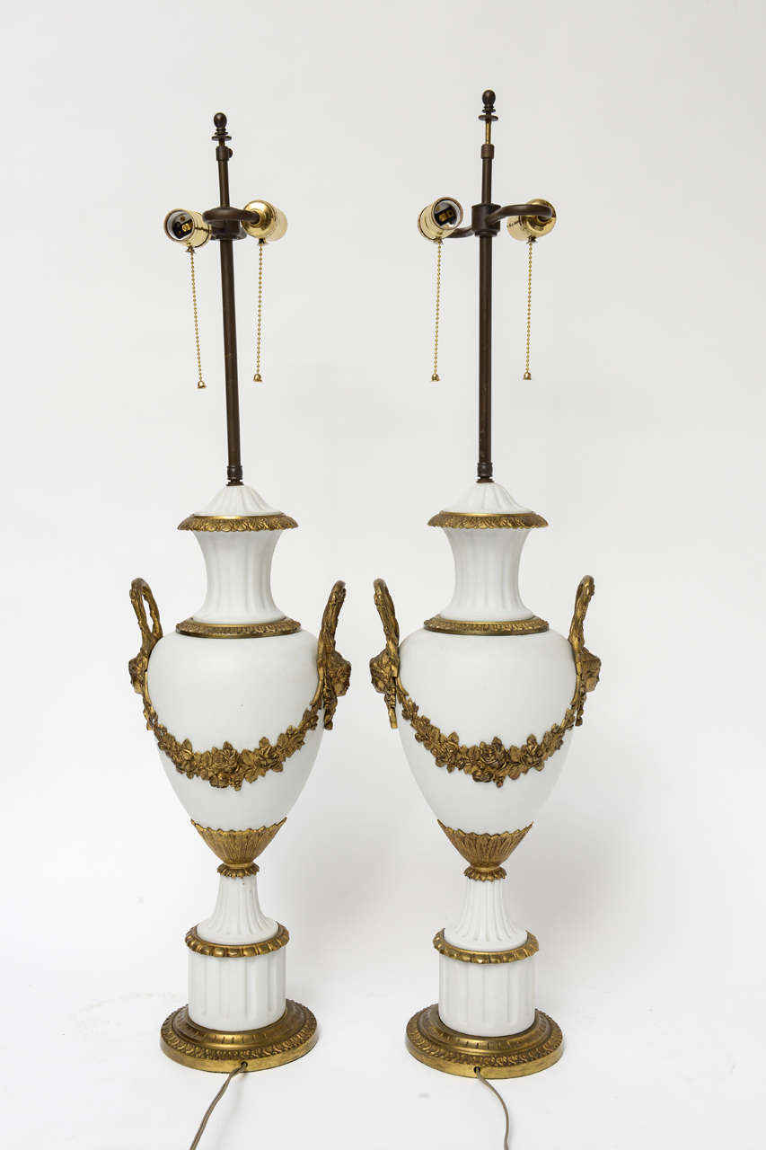 Stately pair of French bisque lamps with beautiful bronze mounts.
Completely rewired for today's use.